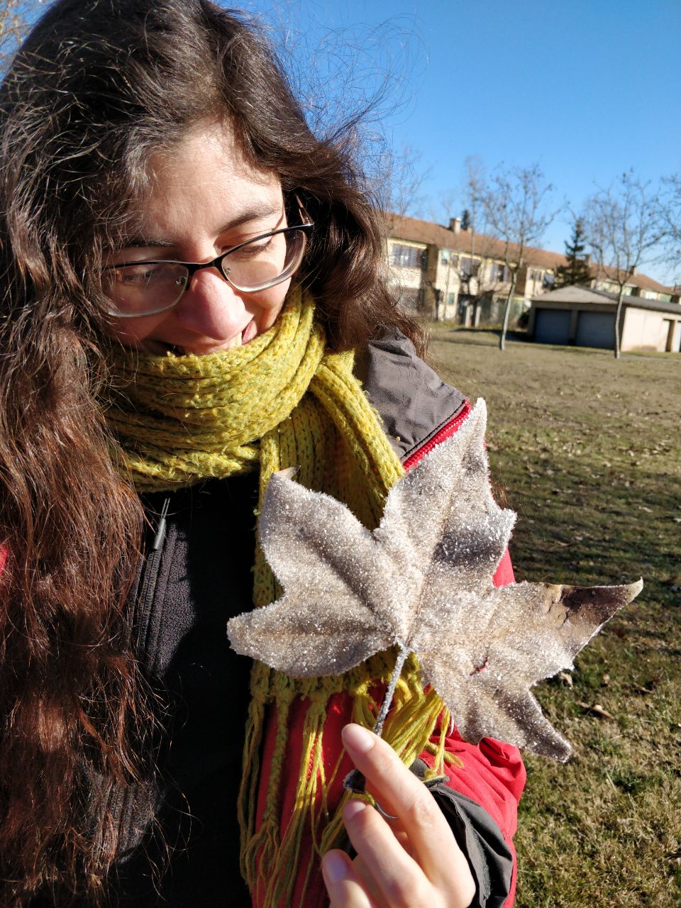 Photo of Marta holding a beautiful frozen leaf.