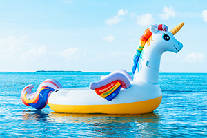 Photo of an inflatable unicorn at the sea by Meritt Thomas